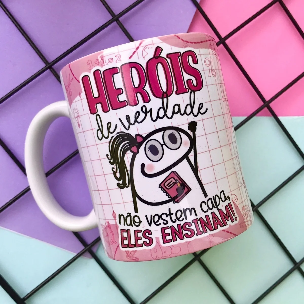 Caneca branca estampada com desenho de personagem e frases em fundo quadriculado rosa