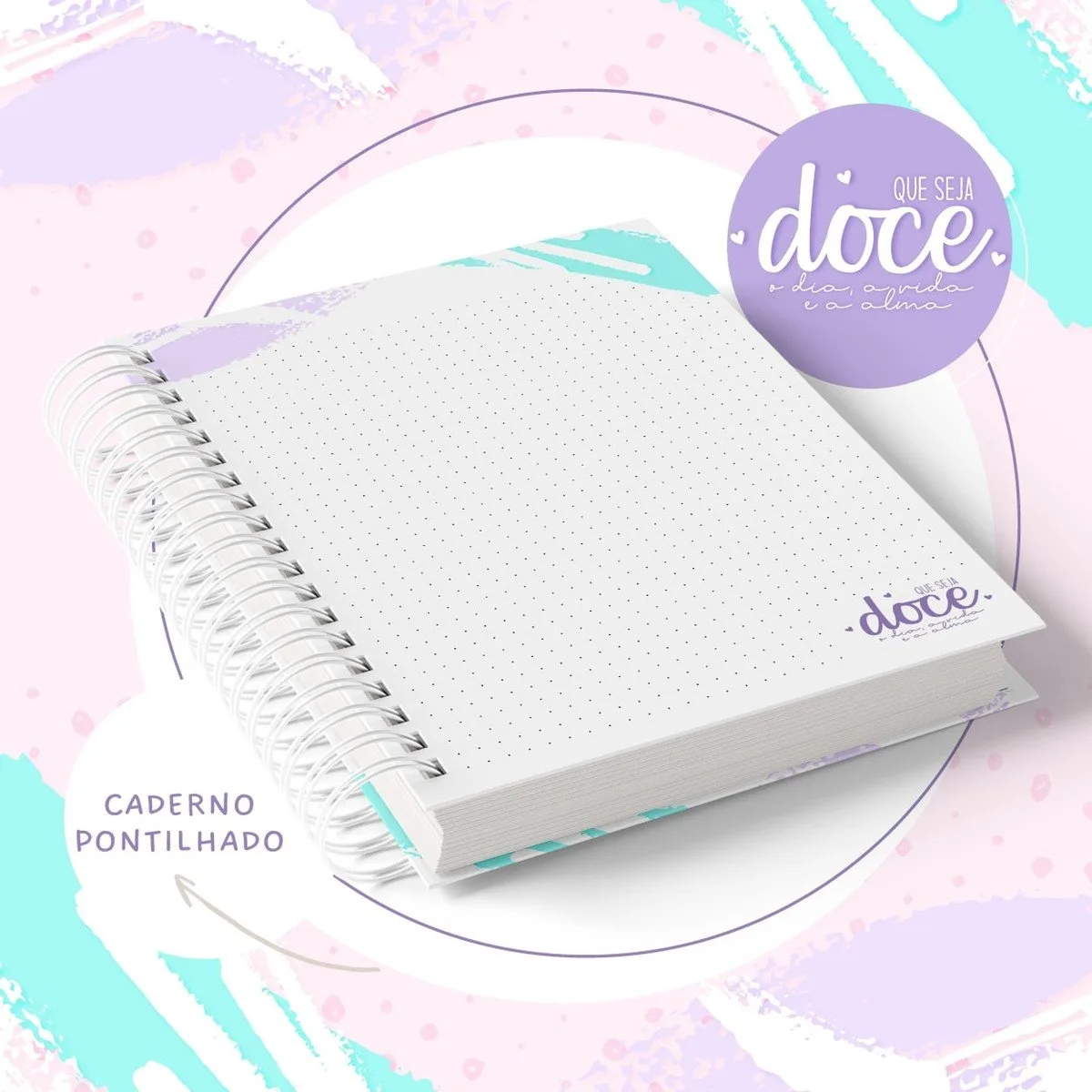 Caderno espiral com folhas pontilhadas sobre fundo abstrato em tons pastéis delicados.