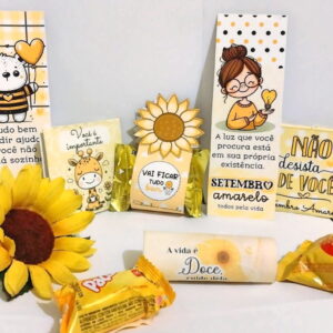 Conjunto de cartões, doces e girassol com mensagens motivacionais em tons de amarelo.