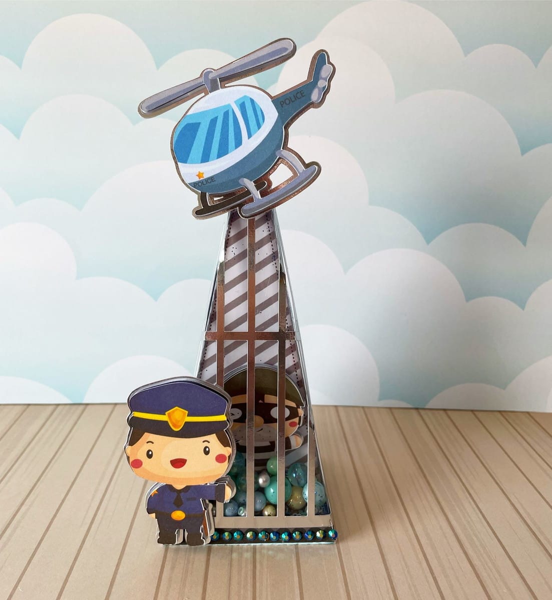 Kit Festa Policia Infantil Digital Completo 4 Imagem de arte digital com tema de polícia, helicóptero e policial em caixa piramidal.