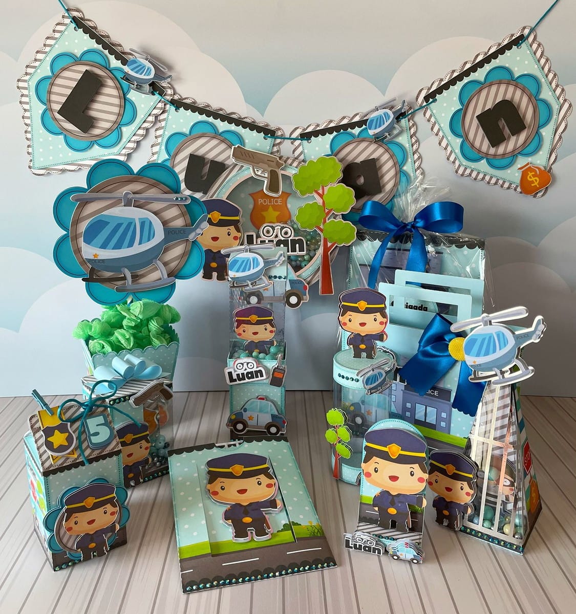 Kit Festa Policia Infantil Digital Completo 1 Designs de festa tema polícia com personagens, veículos e decorações em tons de azul.