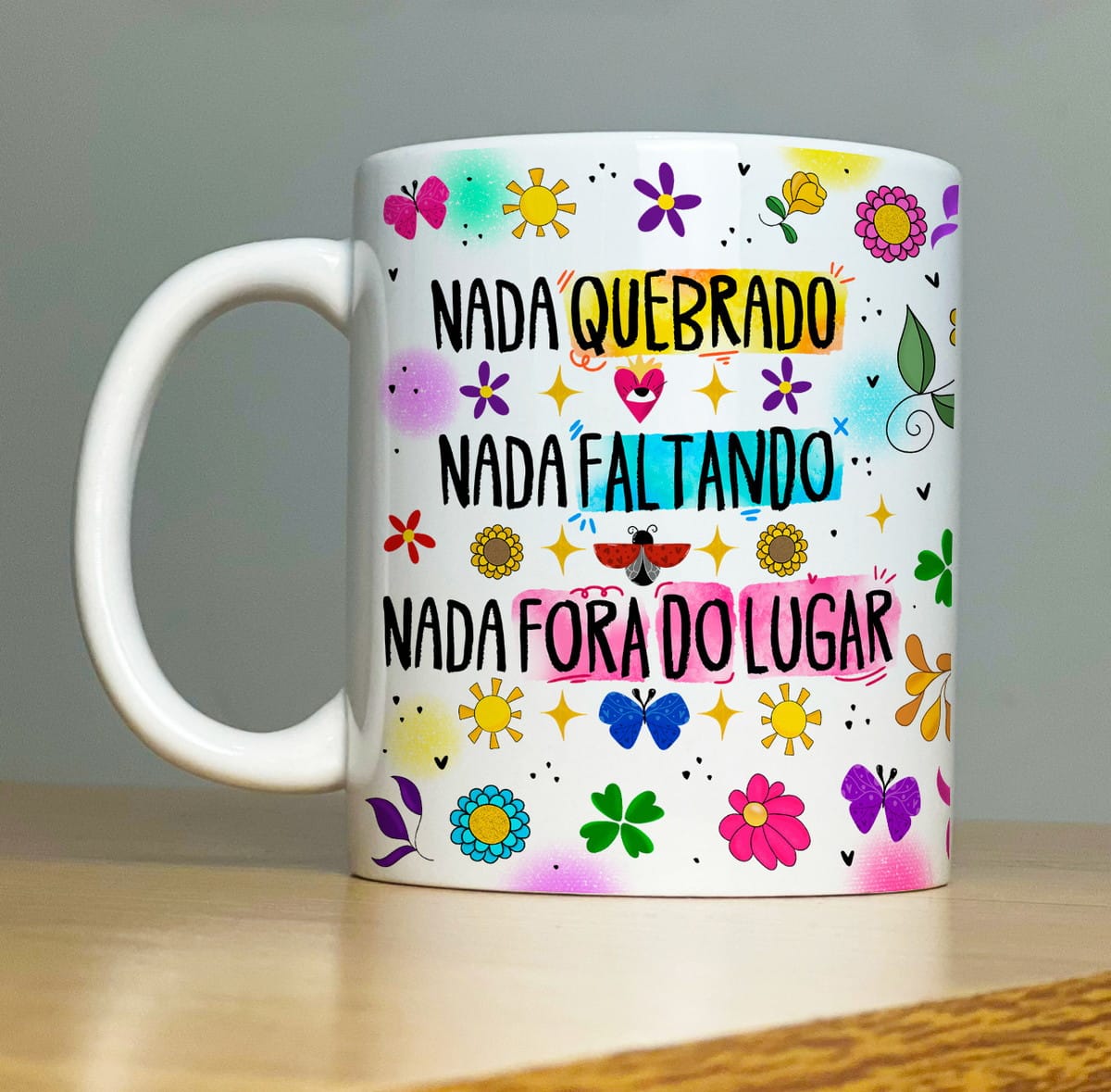 Kit Sublimação Caneca Proteção com 32 Artes em PNG 2 Caneca branca estampada com frases e desenhos coloridos de flores e borboletas.