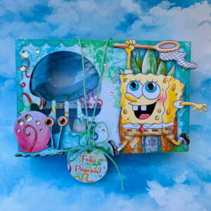 Caixa de Páscoa decorada com personagem amarelo, caracol rosa e tag "Feliz Páscoa!".